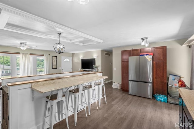 1117 Nelda Dr, Imperial, MO 63052 - kitchen featuring freestanding refrigerator, wood finished floors, a breakfast bar, pendant lighting, and open floor plan