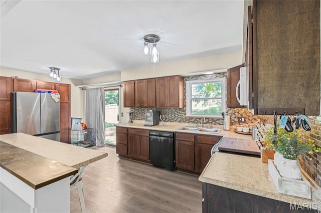 1117 Nelda Dr, Imperial, MO 63052 - kitchen with black dishwasher, freestanding refrigerator, white microwave, and healthy amount of natural light