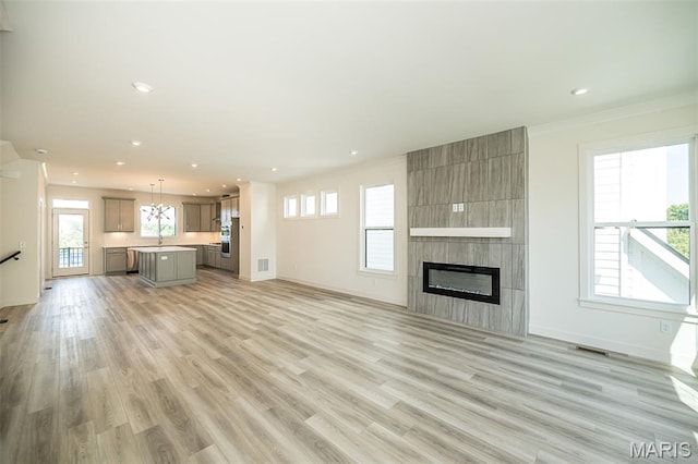 8971 Eager Rd, Richmond Heights, MO 63144 - unfurnished living room with a fireplace, light wood-style floors, recessed lighting, and crown molding