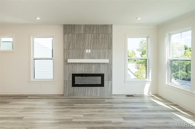 8971 Eager Rd, Richmond Heights, MO 63144 - unfurnished living room with crown molding, a large fireplace, light wood-type flooring, and recessed lighting