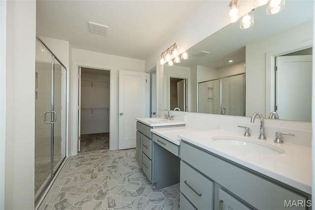 8971 Eager Rd, Richmond Heights, MO 63144 - bathroom featuring double vanity, a stall shower, and a walk in closet