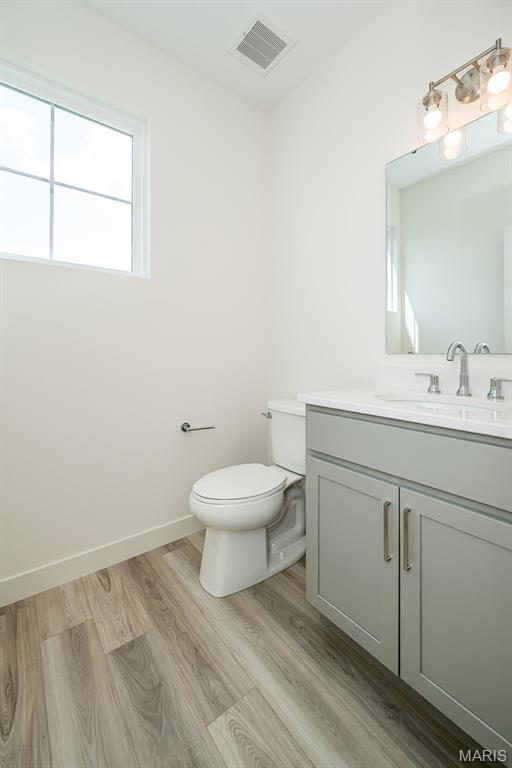 8971 Eager Rd, Richmond Heights, MO 63144 - bathroom featuring vanity and wood finished floors