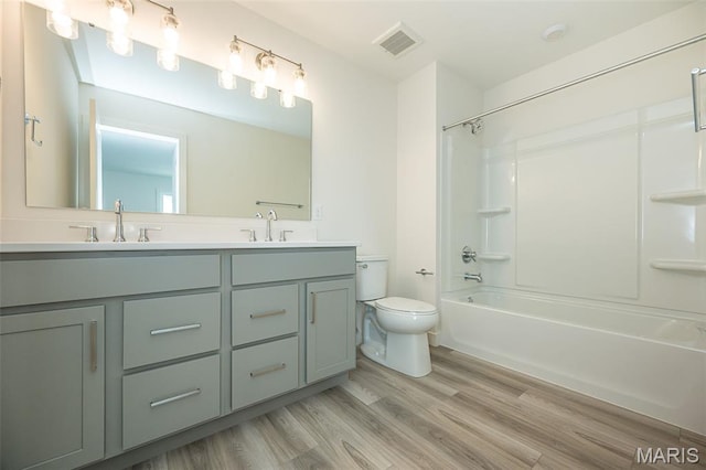 8971 Eager Rd, Richmond Heights, MO 63144 - bathroom with double vanity, wood finished floors, and tub / shower combination