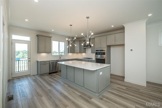 8971 Eager Rd, Richmond Heights, MO 63144 - kitchen featuring gray cabinetry, stainless steel appliances, plenty of natural light, ornamental molding, and recessed lighting
