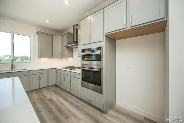 8971 Eager Rd, Richmond Heights, MO 63144 - kitchen with wall chimney range hood, appliances with stainless steel finishes, gray cabinets, decorative backsplash, and recessed lighting
