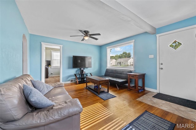 2648 E 27th St, Granite City, IL 62040 - living room featuring wood finished floors, a ceiling fan, beam ceiling, and arched walkways