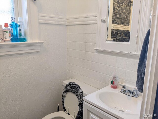 3744 Michigan Ave, Saint Louis, MO 63118 - half bath with vanity, tile walls, and decorative backsplash