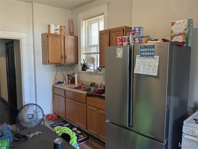 3744 Michigan Ave, Saint Louis, MO 63118 - kitchen featuring freestanding refrigerator, brown cabinetry, and electric stove