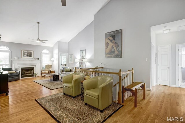 1168 Oak Knoll Manor Ct, Saint Louis, MO 63119 - living room featuring a ceiling fan, high vaulted ceiling, light wood-style floors, and a fireplace