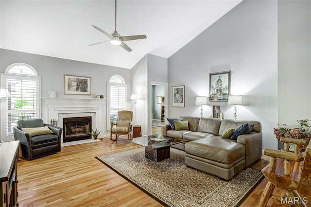1168 Oak Knoll Manor Ct, Saint Louis, MO 63119 - living area with high vaulted ceiling, ceiling fan, plenty of natural light, light wood-style floors, and a fireplace with flush hearth
