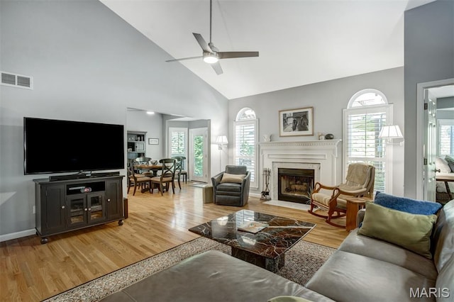 1168 Oak Knoll Manor Ct, Saint Louis, MO 63119 - living area featuring ceiling fan, light wood-type flooring, high vaulted ceiling, and healthy amount of natural light