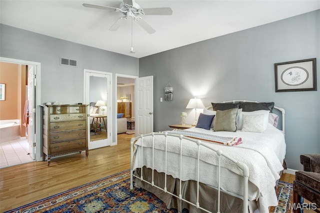 1168 Oak Knoll Manor Ct, Saint Louis, MO 63119 - bedroom with wood finished floors, connected bathroom, and ceiling fan