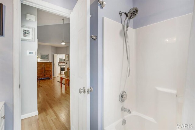 1168 Oak Knoll Manor Ct, Saint Louis, MO 63119 - bathroom featuring washtub / shower combination, wood finished floors, vanity, and ceiling fan