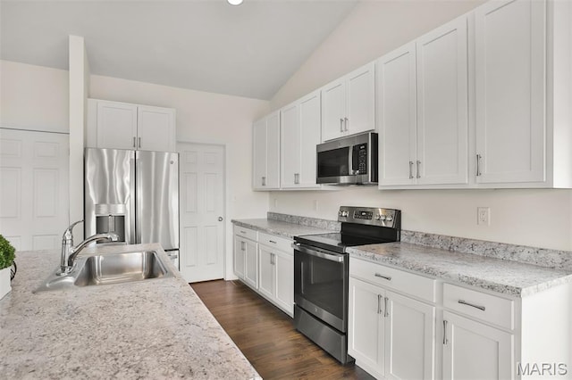2904 Sierra View Ct, Imperial, MO 63052 - kitchen with appliances with stainless steel finishes, lofted ceiling, light countertops, white cabinets, and dark wood-type flooring