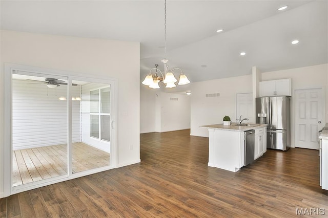 2904 Sierra View Ct, Imperial, MO 63052 - kitchen featuring appliances with stainless steel finishes, a chandelier, dark wood-style flooring, hanging light fixtures, and a center island with sink