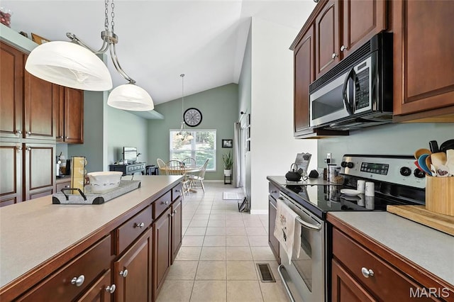 3291 Echo Lake Dr, Byrnes Mill, MO 63025 - kitchen featuring electric range, black microwave, lofted ceiling, light tile patterned flooring, and hanging light fixtures