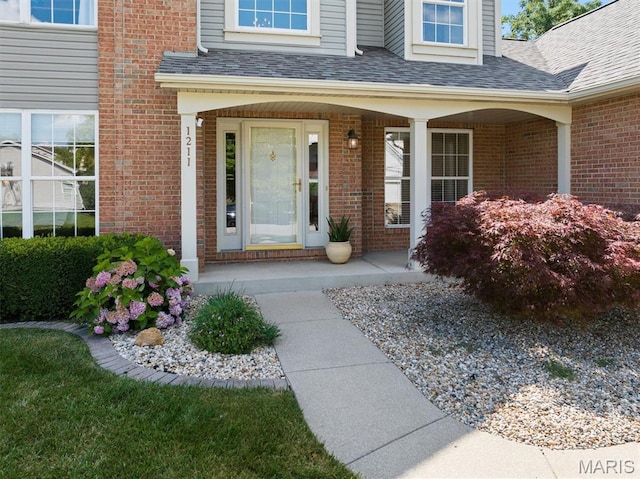 1211 Conrad Ln, Ofallon, IL 62269 - entrance to property featuring brick siding, covered porch, and roof with shingles