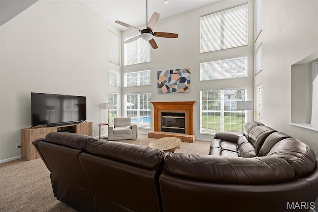 1211 Conrad Ln, Ofallon, IL 62269 - carpeted living room featuring a towering ceiling, ceiling fan, healthy amount of natural light, and a fireplace