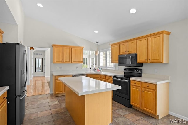 1211 Conrad Ln, Ofallon, IL 62269 - kitchen featuring black range with electric stovetop, stainless steel refrigerator with ice dispenser, light countertops, vaulted ceiling, and a kitchen island