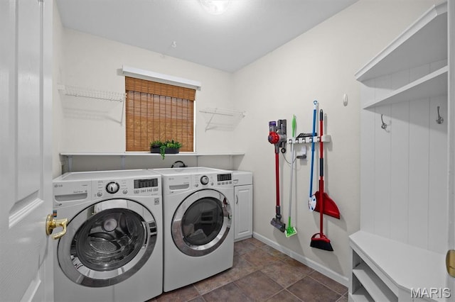 1211 Conrad Ln, Ofallon, IL 62269 - washroom featuring washer and clothes dryer, cabinet space, and dark stone finish floors