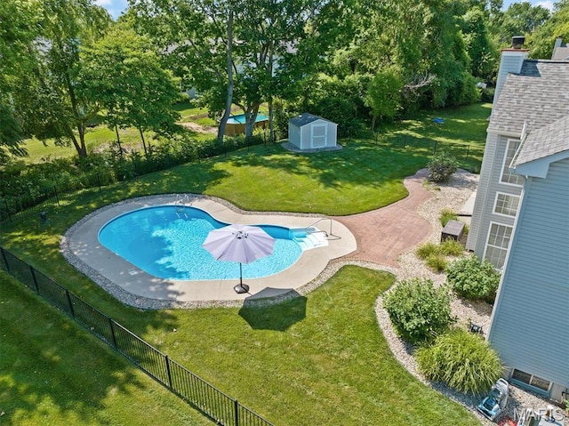 1211 Conrad Ln, Ofallon, IL 62269 - view of swimming pool with a storage unit, a fenced backyard, and view of wooded area