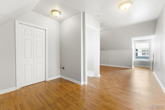 5829 Bartmer Ave, Saint Louis, MO 63112 - additional living space featuring lofted ceiling and wood finished floors