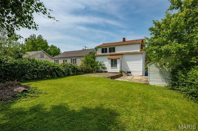 3513 Coronado Dr, Alton, IL 62002 - back of property featuring a patio, a yard, and a chimney