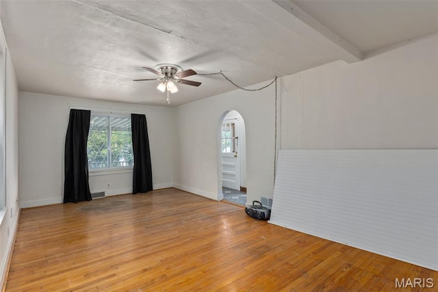 3513 Coronado Dr, Alton, IL 62002 - empty room featuring a ceiling fan, arched walkways, and light wood-style floors
