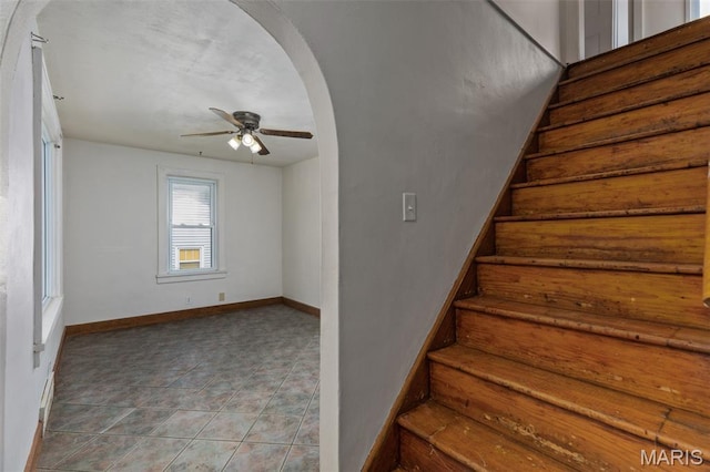 3513 Coronado Dr, Alton, IL 62002 - stairway featuring arched walkways, ceiling fan, and tile patterned floors
