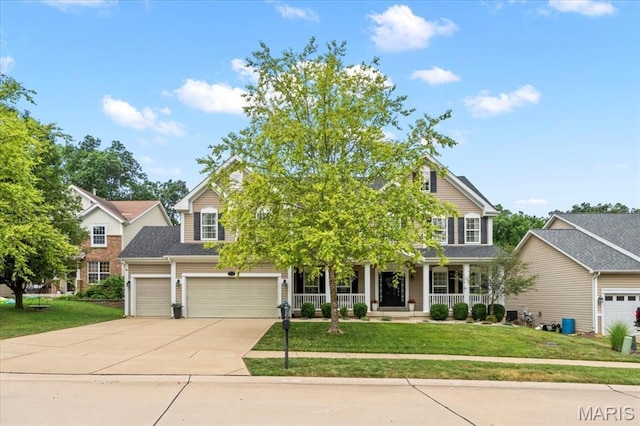 1412 Heritage Valley Dr, High Ridge, MO 63049 - view of front facade with concrete driveway, covered porch, a front yard, and a garage