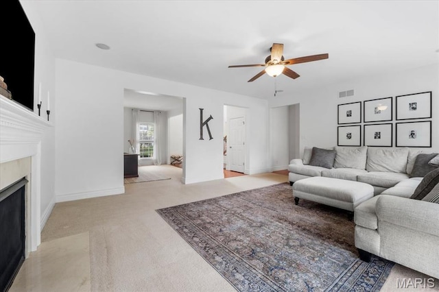 1412 Heritage Valley Dr, High Ridge, MO 63049 - living area featuring a ceiling fan, a premium fireplace, and light colored carpet