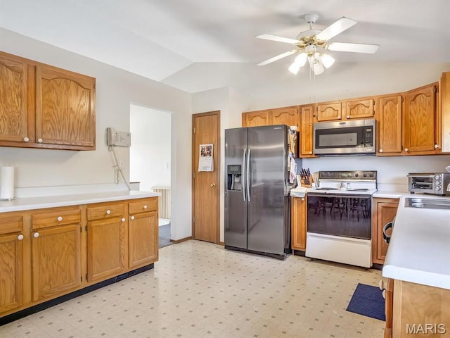 1 Wild Horse Ct, Troy, IL 62294 - kitchen featuring appliances with stainless steel finishes, vaulted ceiling, radiator, ceiling fan, and light countertops
