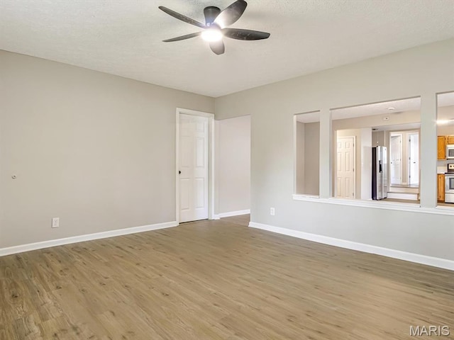 628 E Chain Of Rocks Rd, Granite City, IL 62040 - empty room featuring a ceiling fan, light wood-type flooring, and a textured ceiling