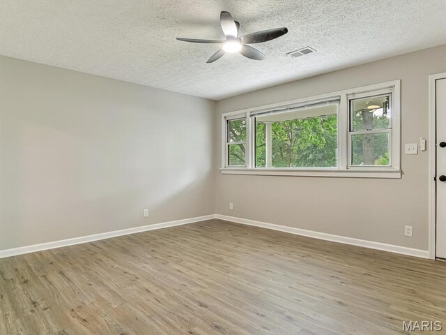 628 E Chain Of Rocks Rd, Granite City, IL 62040 - spare room featuring ceiling fan, a textured ceiling, and wood finished floors