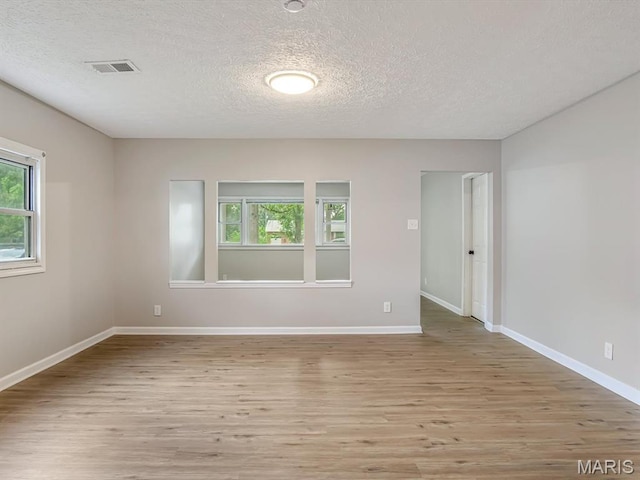 628 E Chain Of Rocks Rd, Granite City, IL 62040 - unfurnished room with light wood finished floors and a textured ceiling