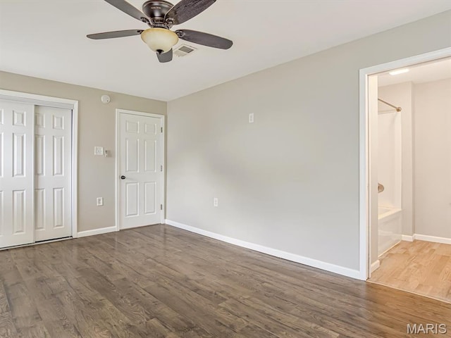 628 E Chain Of Rocks Rd, Granite City, IL 62040 - unfurnished bedroom with wood finished floors, a closet, ensuite bath, and a ceiling fan