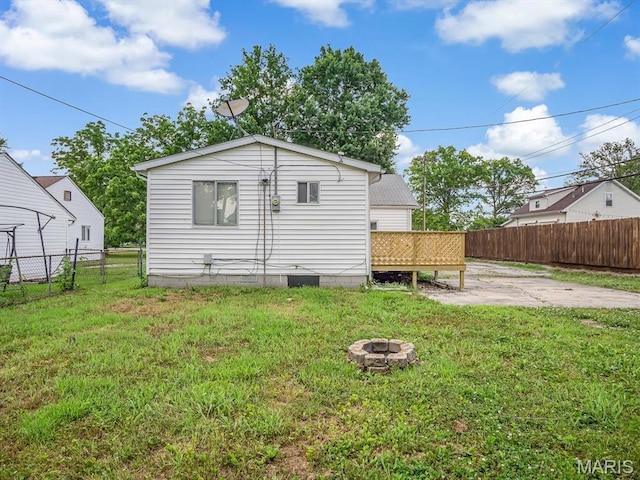 628 E Chain Of Rocks Rd, Granite City, IL 62040 - back of property featuring a fire pit, a patio area, and a deck