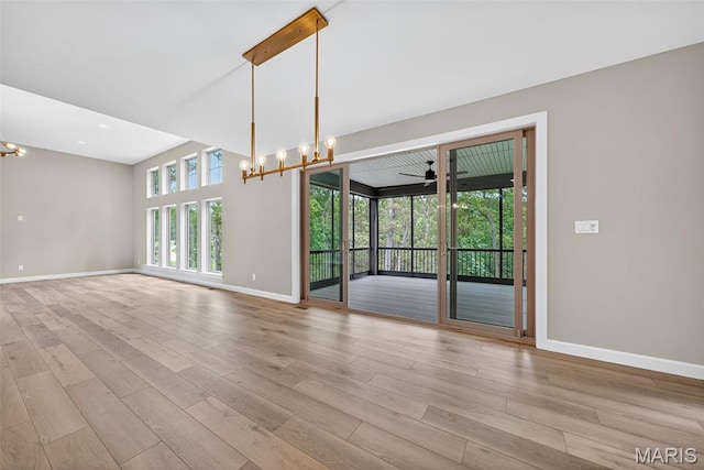 212 Terradel Trl, Foristell, MO 63348 - unfurnished room featuring a chandelier, light wood-style flooring, and ceiling fan