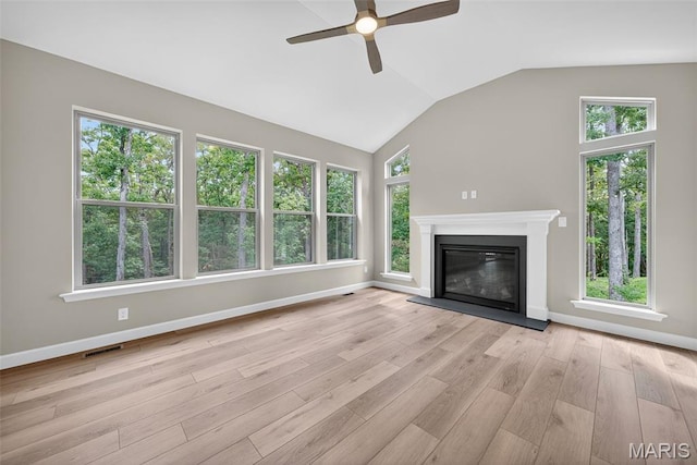 212 Terradel Trl, Foristell, MO 63348 - unfurnished living room featuring a ceiling fan, light wood finished floors, a glass covered fireplace, and vaulted ceiling