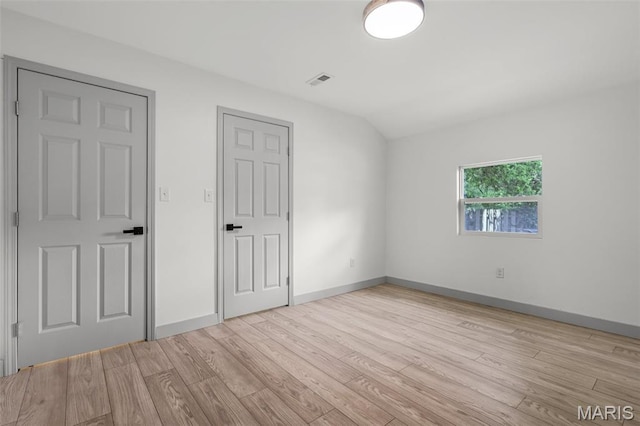715 Westchester Ct, Kirkwood, MO 63122 - unfurnished bedroom featuring light wood-type flooring and vaulted ceiling