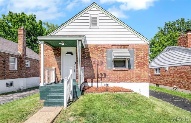 1164 Ursula Ave, University City, MO 63130 - view of front of house featuring a front yard and brick siding