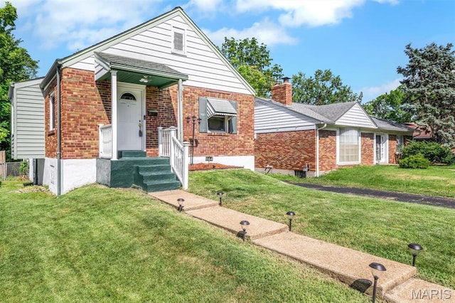 1164 Ursula Ave, University City, MO 63130 - view of front of property with brick siding, a front lawn, and a chimney