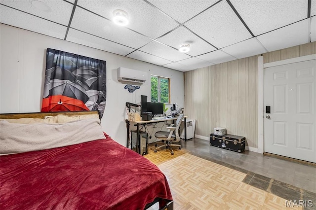 1164 Ursula Ave, University City, MO 63130 - bedroom featuring a wall mounted AC, a drop ceiling, an office area, and wooden walls