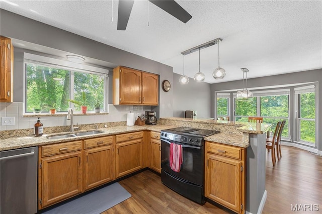 391 Carriage Trail Ct, Ofallon, MO 63368 - kitchen with black range with electric cooktop, stainless steel dishwasher, a peninsula, ceiling fan, and dark wood finished floors
