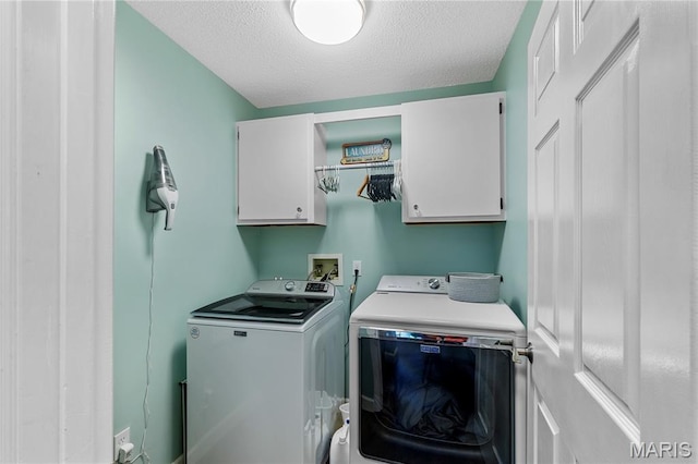 391 Carriage Trail Ct, Ofallon, MO 63368 - laundry area featuring cabinet space, washer and dryer, and a textured ceiling