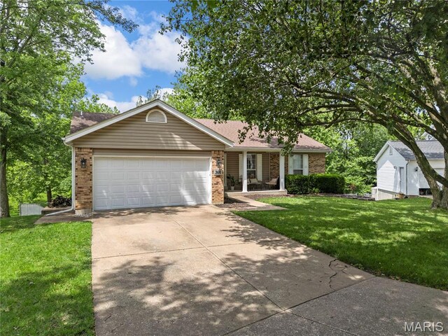391 Carriage Trail Ct, Ofallon, MO 63368 - view of front of home featuring brick siding, driveway, a front yard, and a garage