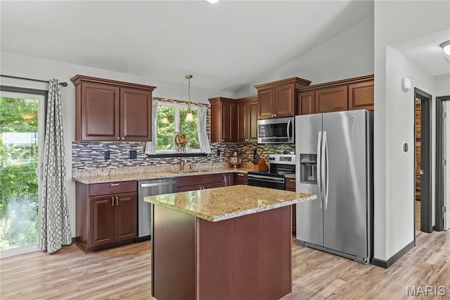 111 Rivers Edge Dr, Moscow Mills, MO 63362 - kitchen featuring appliances with stainless steel finishes, backsplash, plenty of natural light, light wood-style flooring, and lofted ceiling