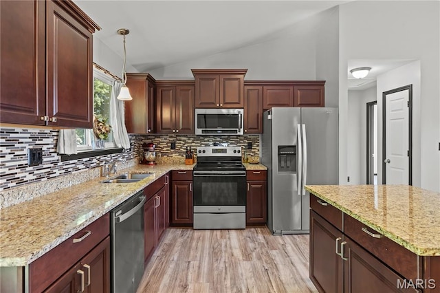111 Rivers Edge Dr, Moscow Mills, MO 63362 - kitchen with stainless steel appliances, lofted ceiling, decorative backsplash, hanging light fixtures, and light wood-type flooring