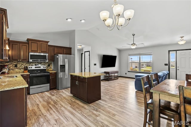 111 Rivers Edge Dr, Moscow Mills, MO 63362 - kitchen featuring stainless steel appliances, lofted ceiling, ceiling fan, tasteful backsplash, and a center island