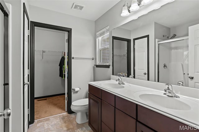 111 Rivers Edge Dr, Moscow Mills, MO 63362 - bathroom featuring a stall shower, double vanity, and a spacious closet